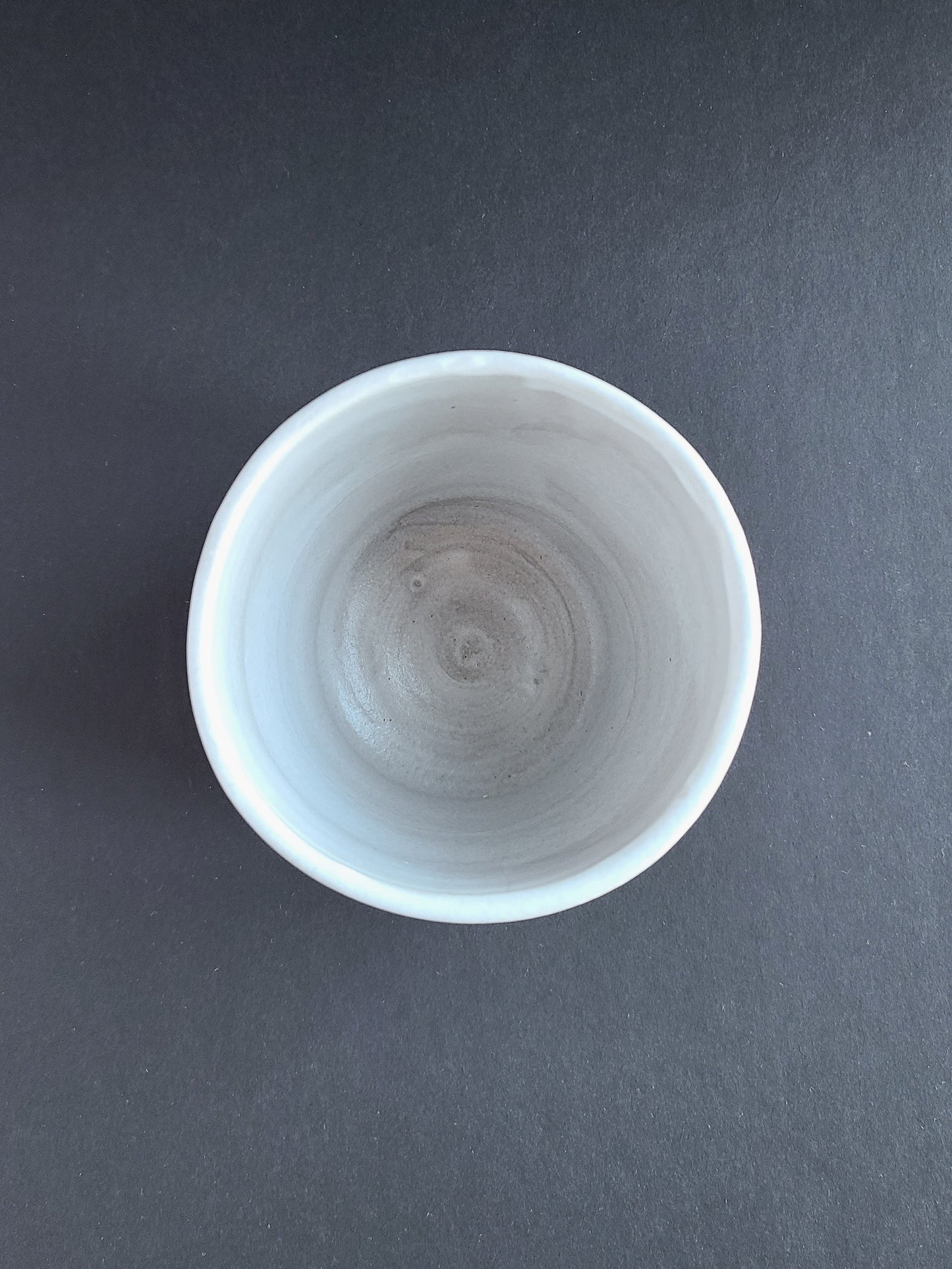 White cup in red stoneware